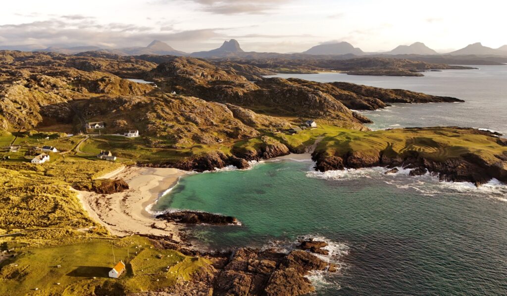 Aerial drone view of the turquoise water and white sand at Clachtoll Beach Northwest Highlands